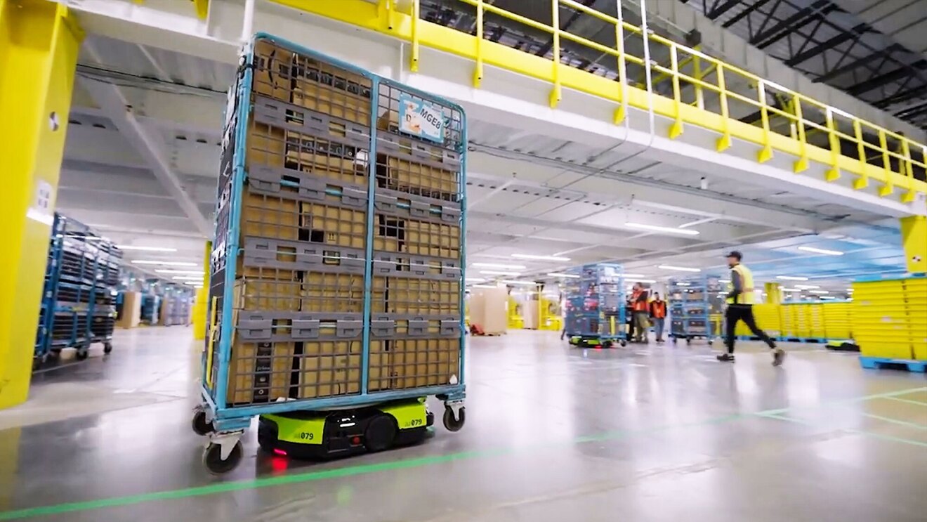 Amazon employee directing a Proteus robot with spoken commands
